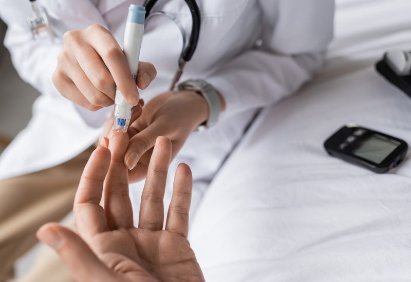 cropped-view-of-doctor-with-lancet-pen-checking-bl-2026-03-25-23-54-42-utc-web